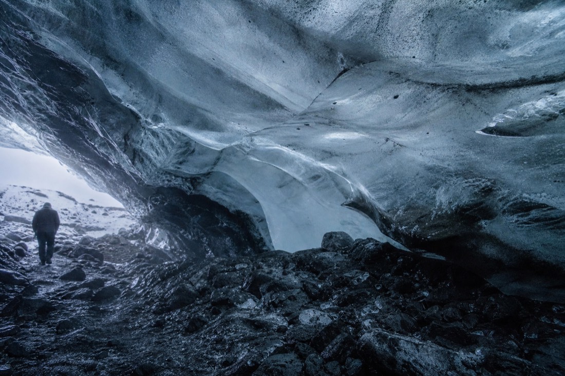Ash-streaked ice inside the Katla ice cave under Mýrdalsjökull, reached by super jeep from Vík