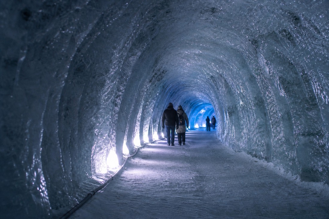 The lit corridor of the man-made ice tunnel inside Langjökull glacier