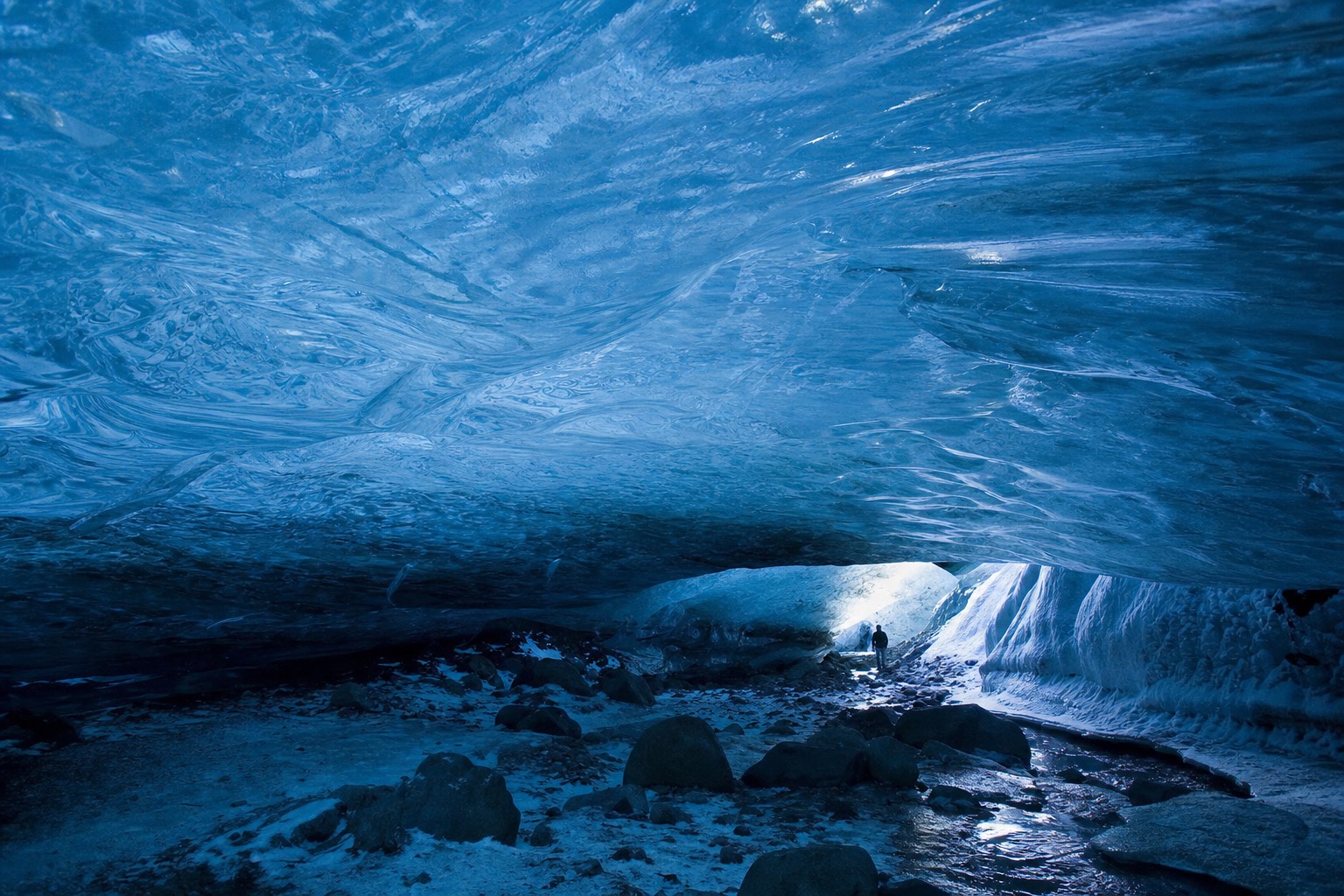 The blue ceiling of a natural ice cave inside Vatnajökull on an Iceland winter ice cave tour